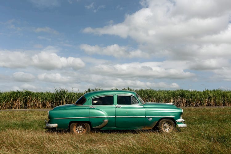 Old Vintage Car Parked On Grass Field