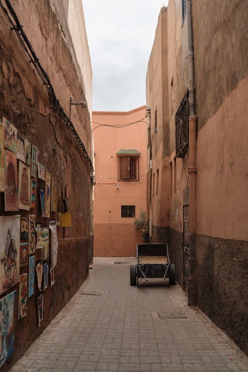 Free An urban alleyway with artwork displayed on the wall, featuring rustic architecture. Stock Photo