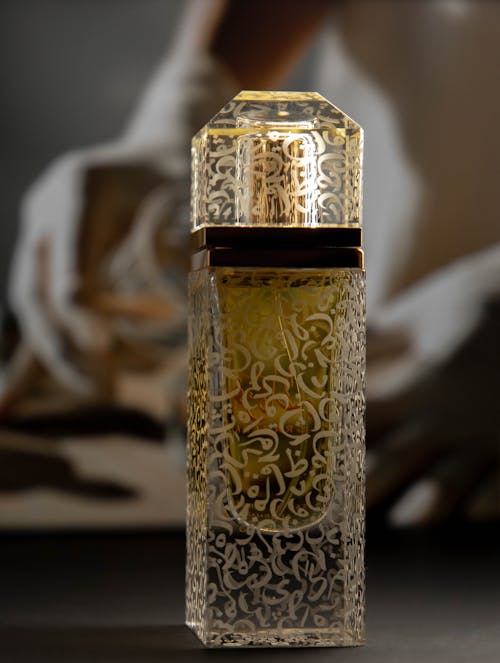 Close-Up Shot of Gold and Clear Perfume Bottle