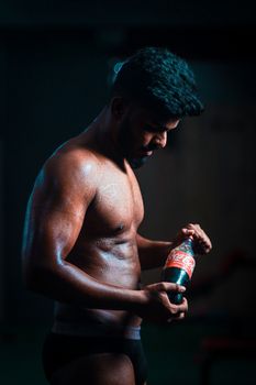 Athlete holding a Coca Cola bottle, emphasizing fitness and lifestyle.