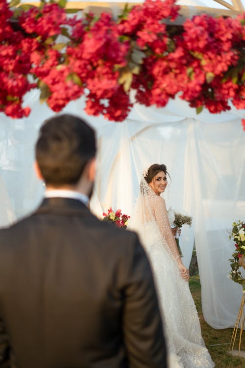A Bride Looking at the Groom Walking Towards Her
