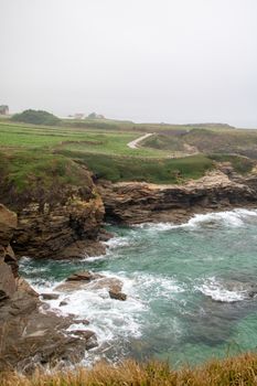 Experience the rugged beauty of Foz, Spain with its stunning cliffs and crashing ocean waves.