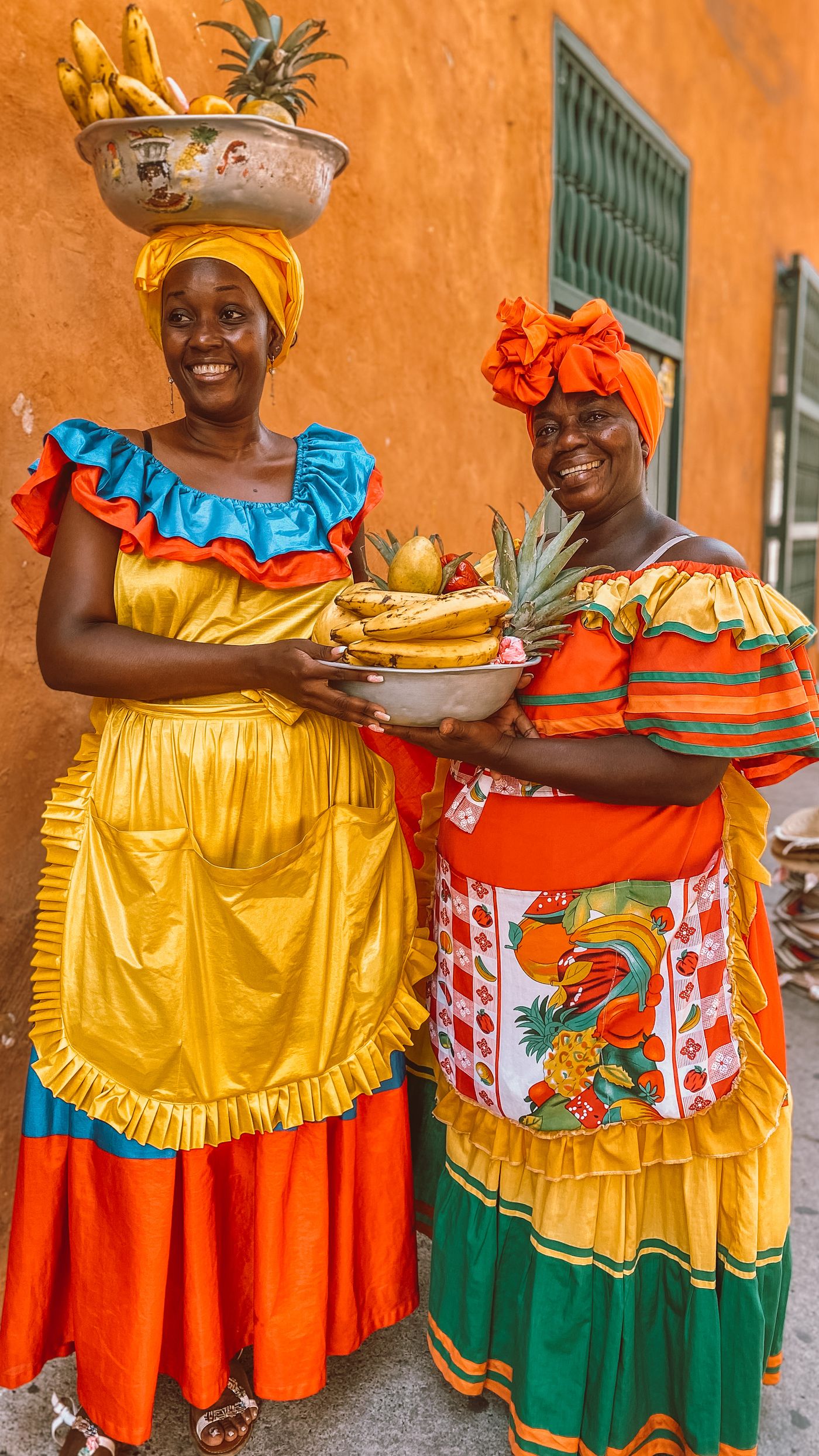 Mujeres colombianas sonrientes con frutas frescas