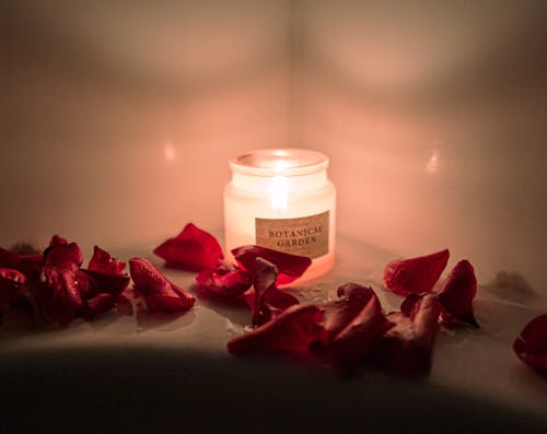 Red Petals and a Lighted Candle