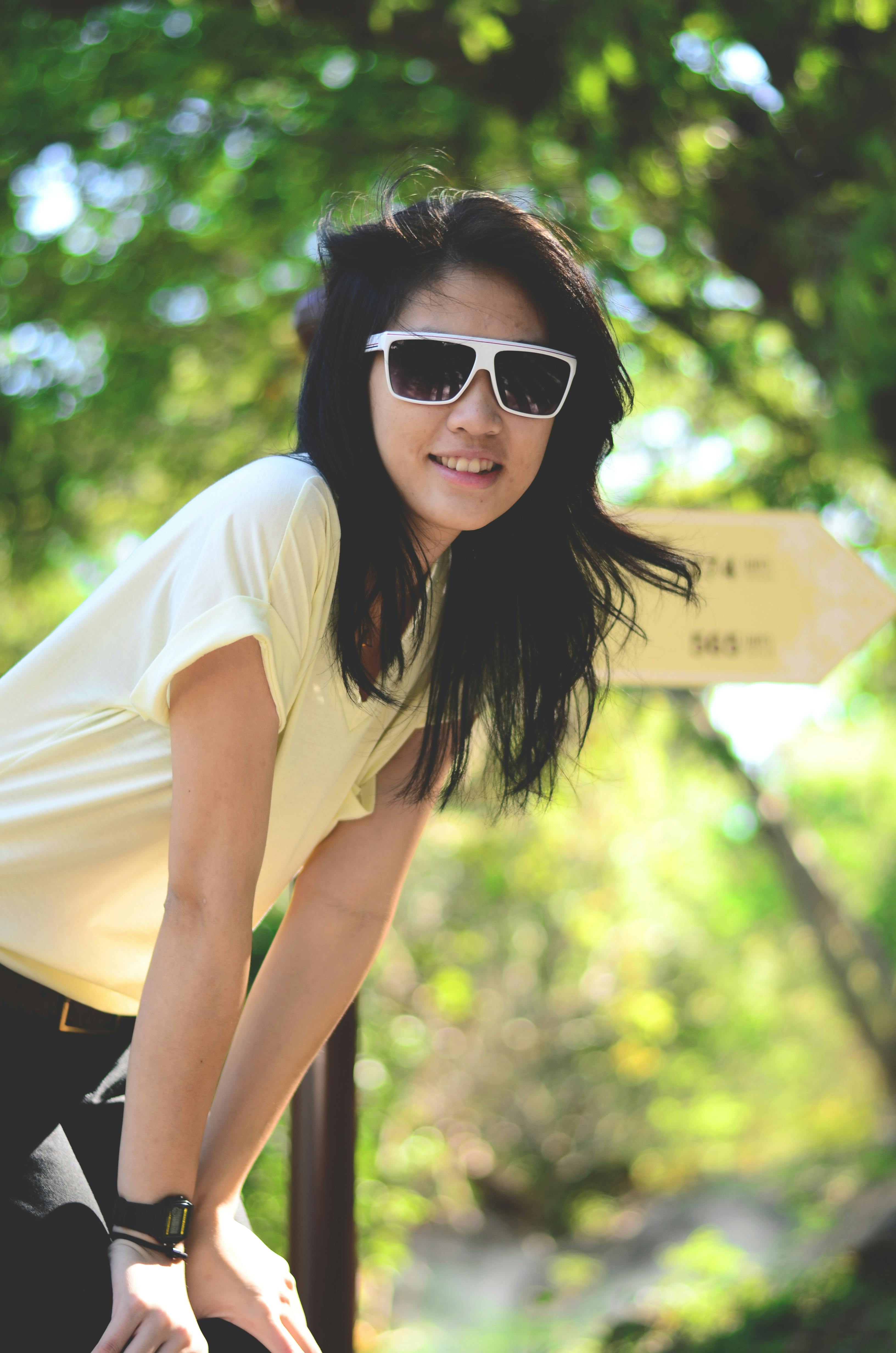 woman in yellow shirt with hands on knee