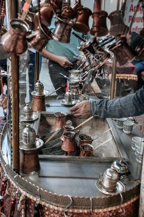 Free A bustling street scene capturing the art of traditional Turkish coffee making. Stock Photo