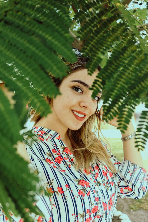 Woman Standing near Green Leaves