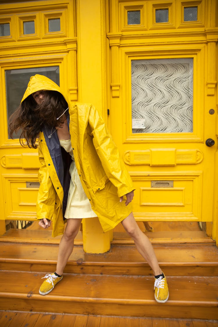 A Woman Wearing A Yellow Raincoat 