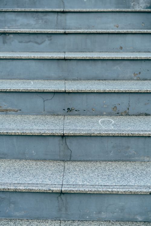 Free Detailed view of a worn concrete staircase with visible cracks and a gritty urban feel. Stock Photo