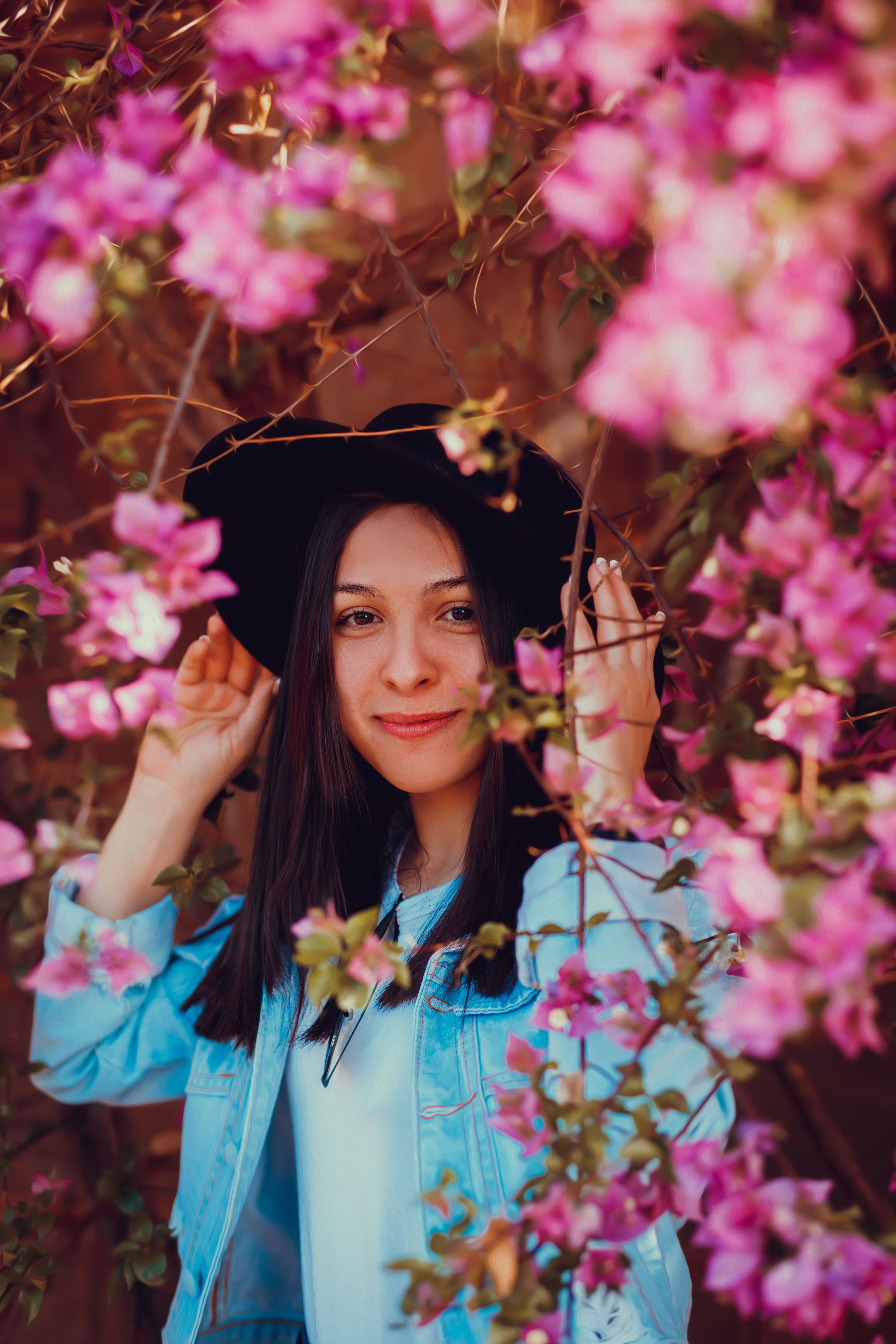 A Woman in Denim Jacket Standing near Flowers · Free Stock Photo
