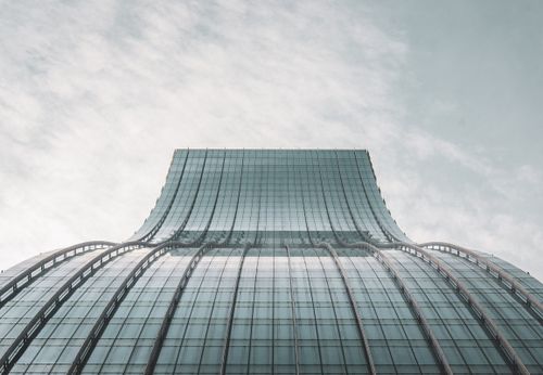 Free Striking low angle view of a modern skyscraper against a cloudy sky in Pasig, Philippines. Stock Photo