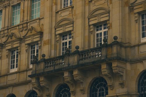 Free Close-up of a traditional architecture facade with detailed balconies and windows. Stock Photo