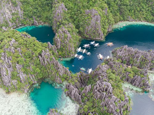 Free Breathtaking aerial view of turquoise waters and limestone cliffs in Coron, Philippines. Stock Photo