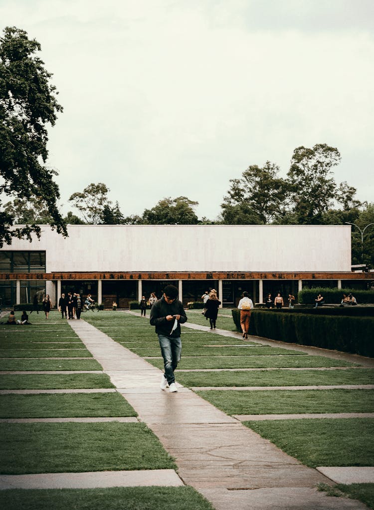 People Walking On Green City Square