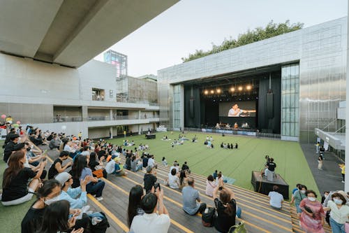 People Watching a Stage Performance in a Modern Cultural Center 