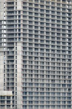 Close-up view of a brutalist high-rise building showcasing grid-like design and concrete material.