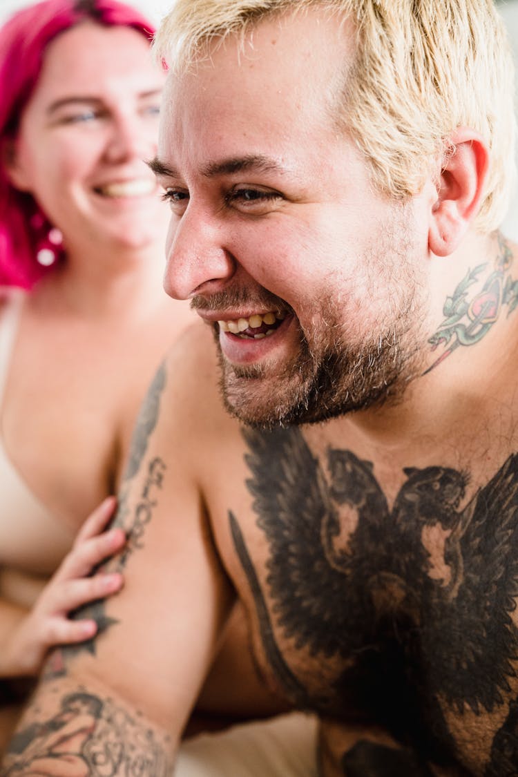 A Couple Sitting And Smiling