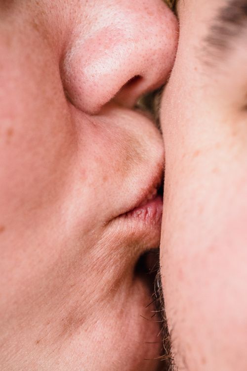 Free Intimate close-up of two people kissing, highlighting affection and connection. Stock Photo