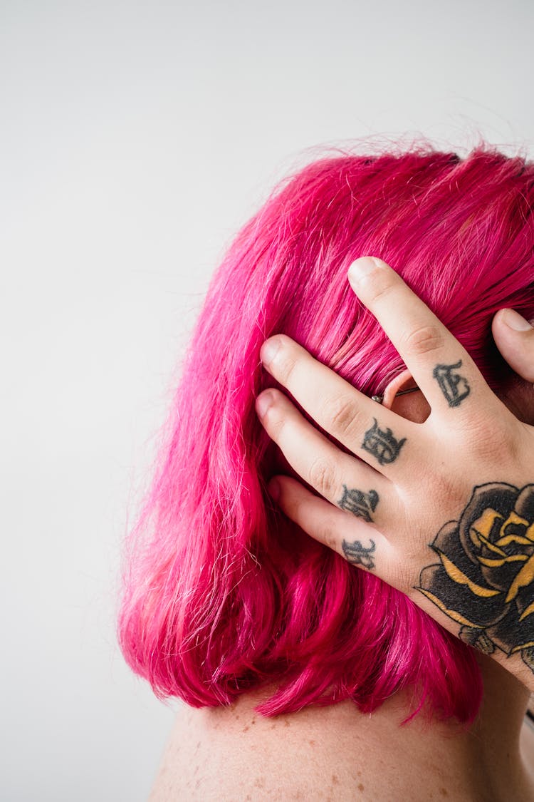 Man Hand With Tattoos Touching Woman With Pink Hair