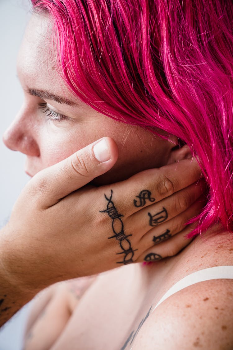 Man Hand With Tattoos Touching Woman Face