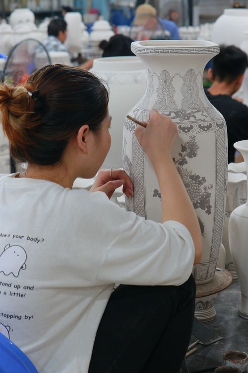 Free A woman artist hand-paints a large ceramic vase in a Quang Ngai workshop. Stock Photo