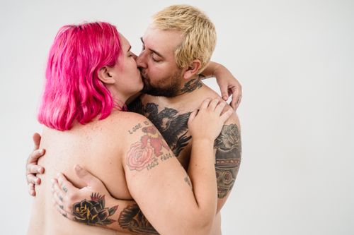 Free A loving couple embracing, showcasing tattoos and body positivity. Stock Photo