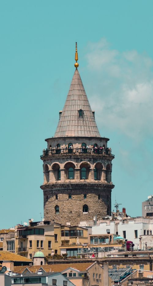 Free The historic Galata Tower in Istanbul stands tall against a clear blue sky, showcasing its architectural beauty. Stock Photo