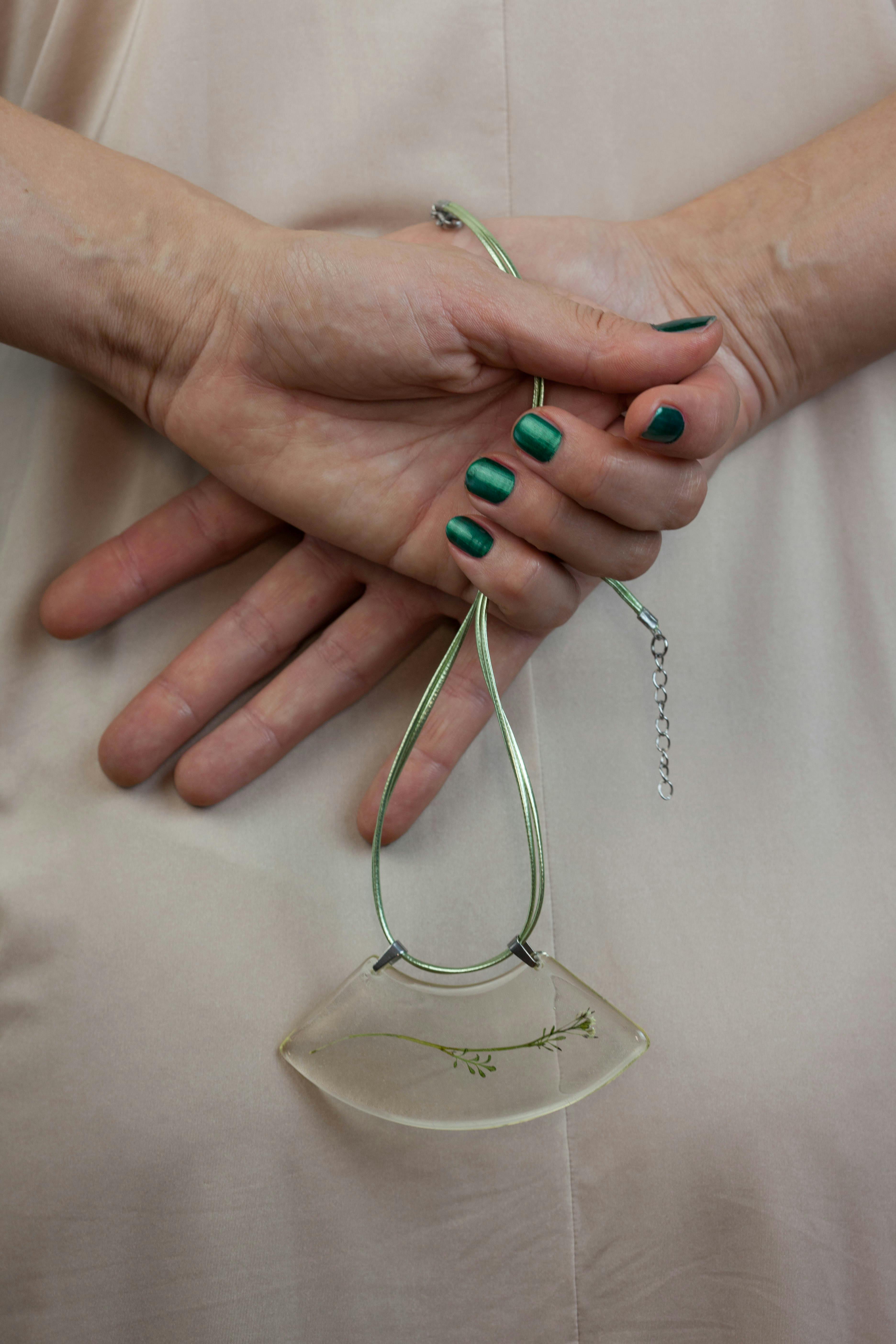 Free Person Holding Green Necklace Stock Photo