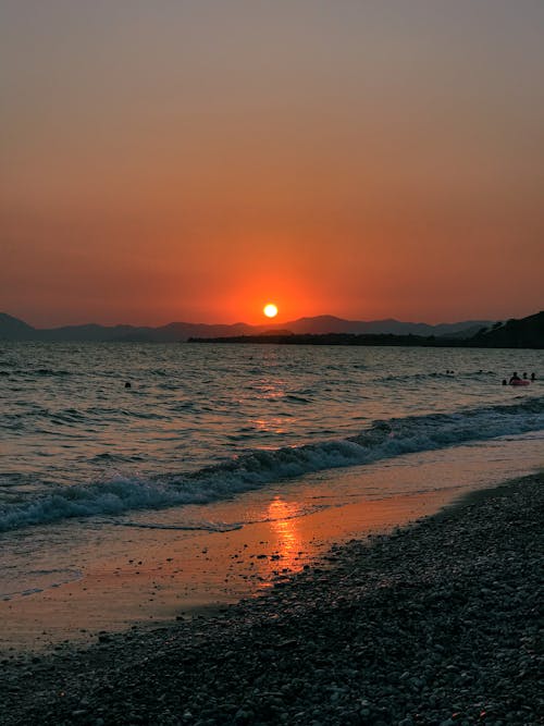 Waves Crashing on Shore at Sunset