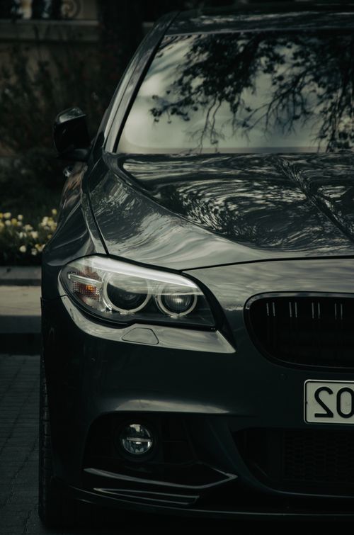 Free A sleek black car parked on a street in Baku, Azerbaijan, showcasing modern design. Stock Photo
