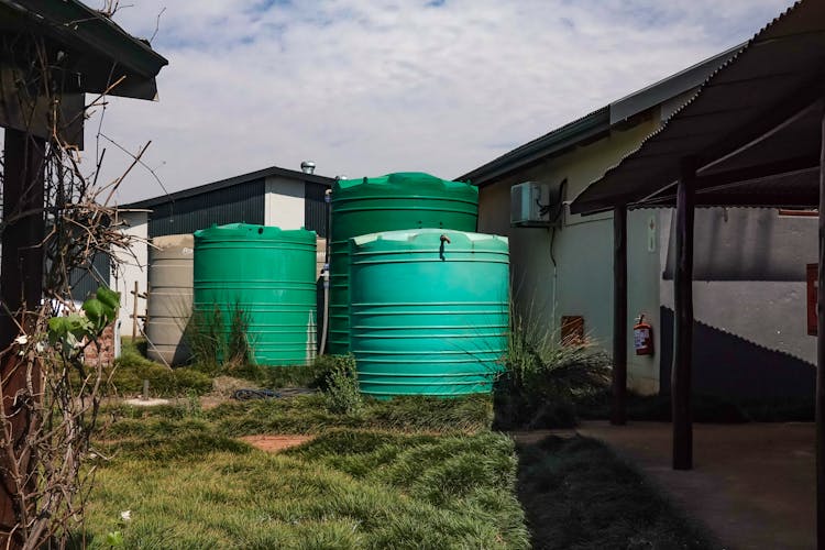 Large Containers Standing By The Building On A Farm 