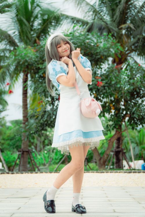 Free Cheerful woman in cosplay costume poses outdoors with palm trees, exuding playfulness. Stock Photo