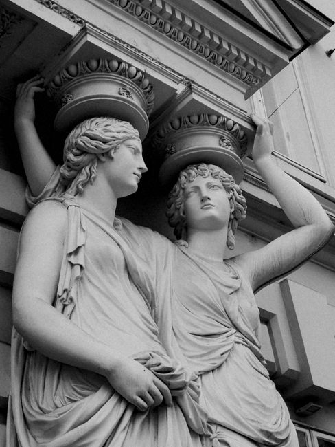 Black and white image of neoclassical caryatids at Palais Pallavicini in Vienna, Austria.