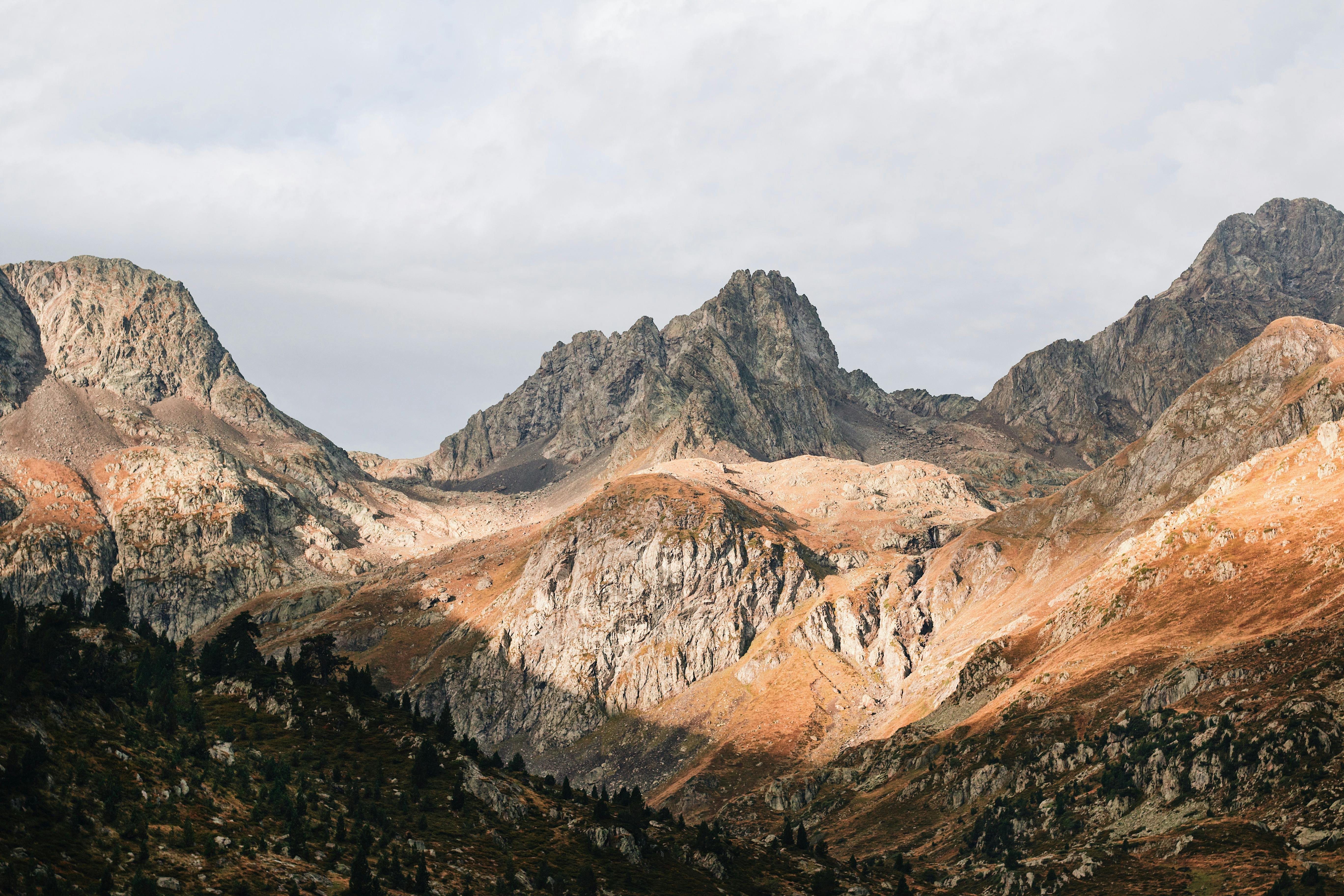 brown and gray mountains under white cloudy sky