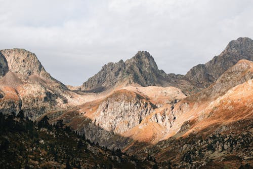 Brown and Gray Mountains Under White Cloudy Sky