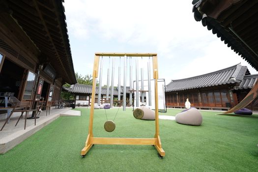 A serene traditional Korean courtyard with musical instruments on display, perfect for a cultural experience.