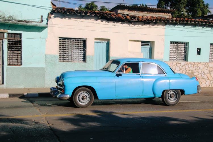 Man In Retro Car On City Street