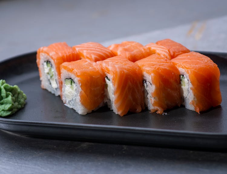 Pieces Of Salmon Sushi On Black Plate