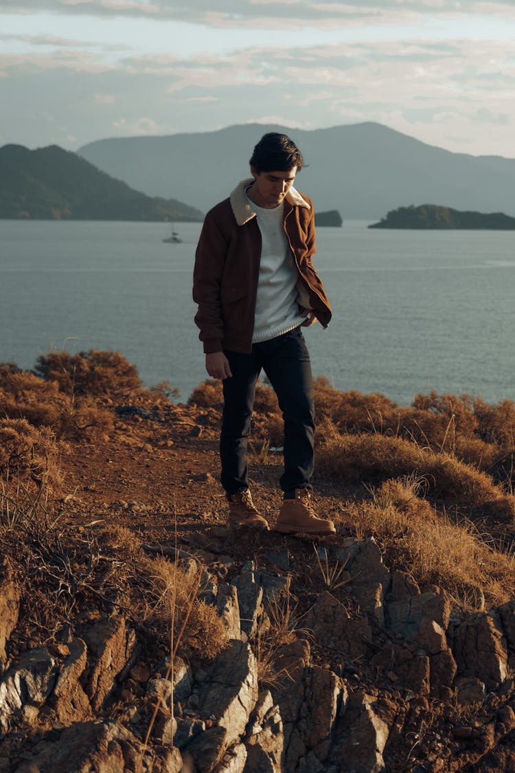 Man Walking Along Lake Shore