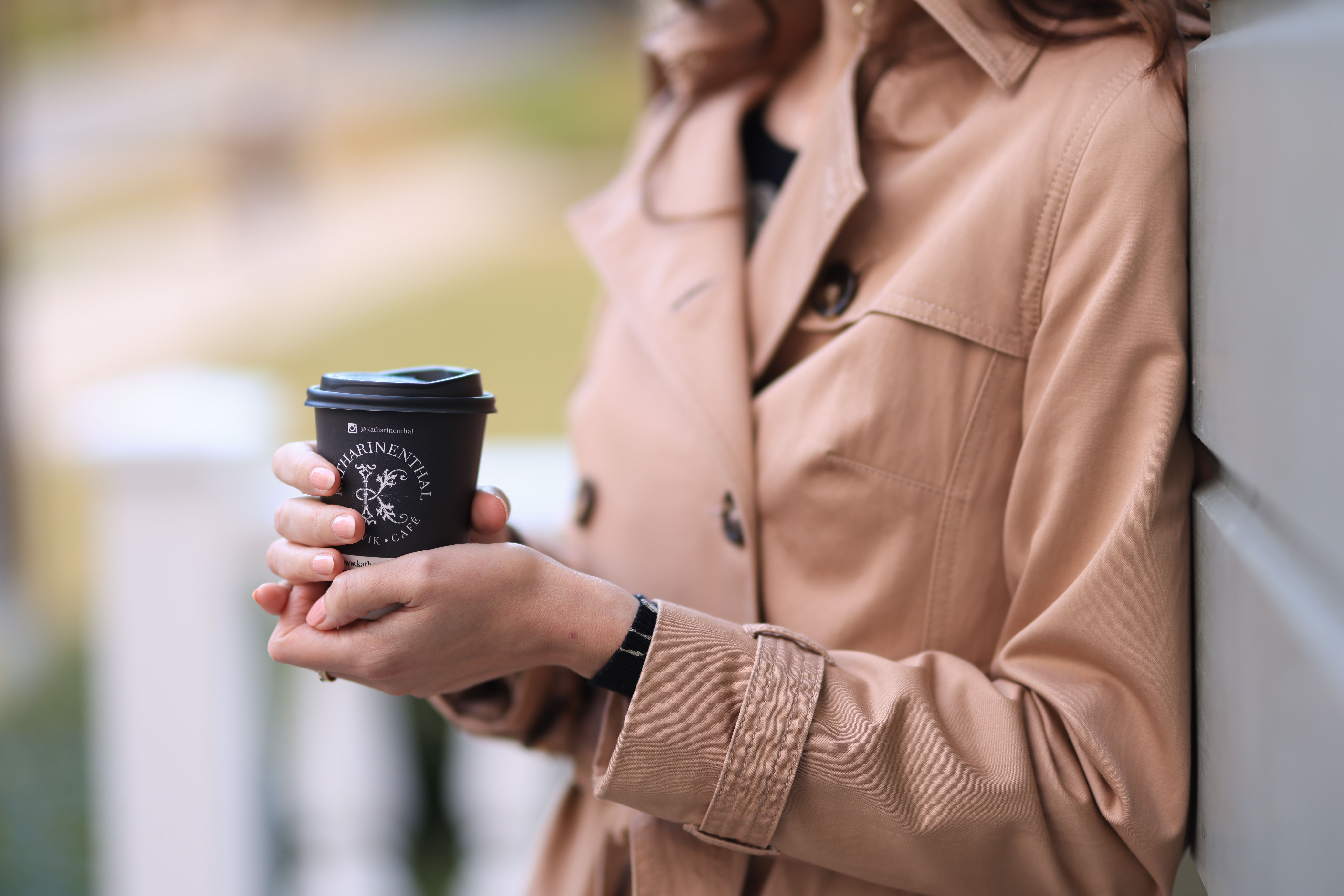 A Woman Holding a Paper Cup of Coffee · Free Stock Photo
