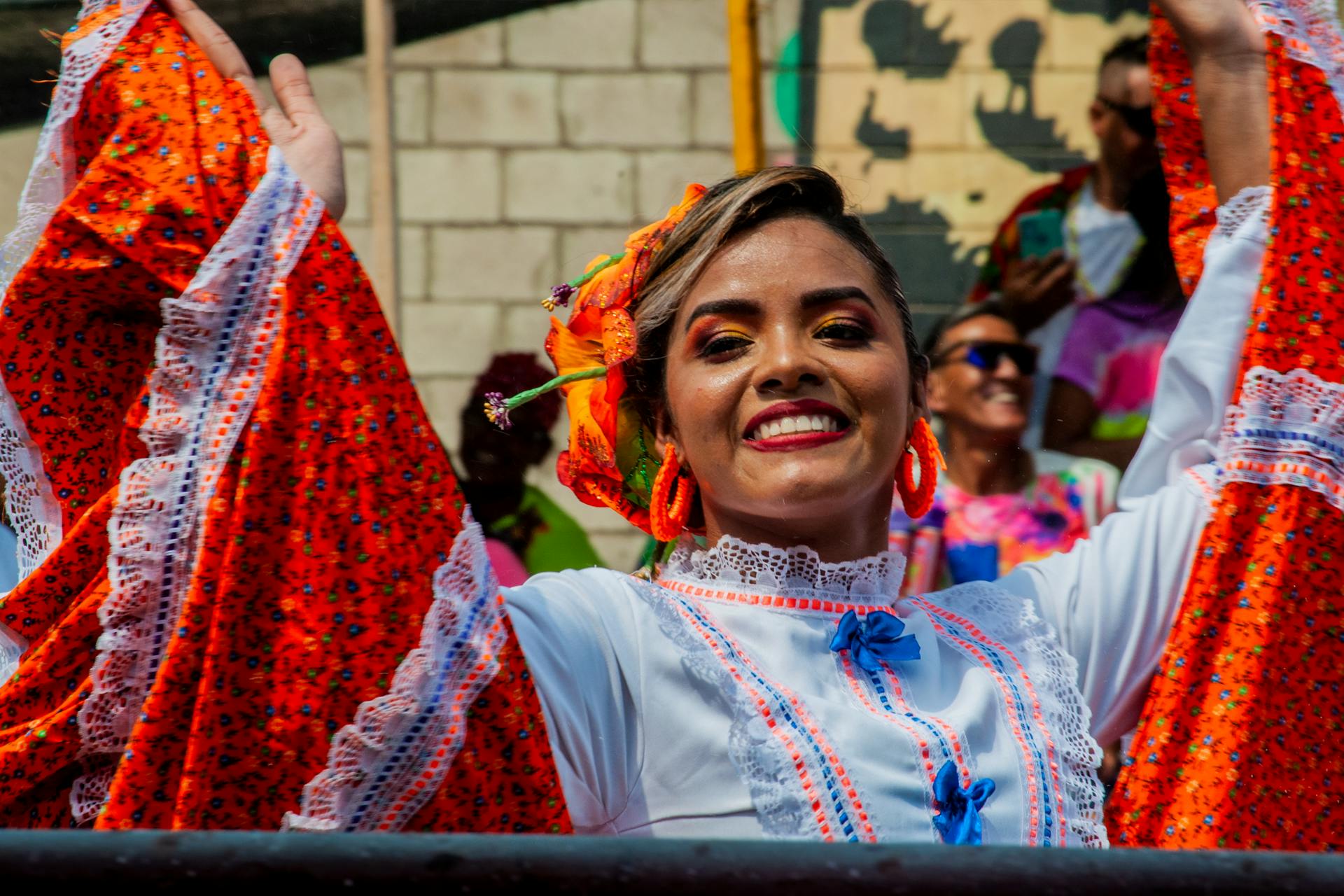 Woman celebrating in traditional costume at Barranquilla festival, exuding joy.