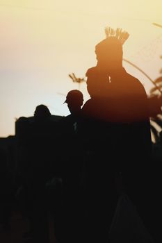 Silhouettes of people during the golden hour, capturing a serene moment.