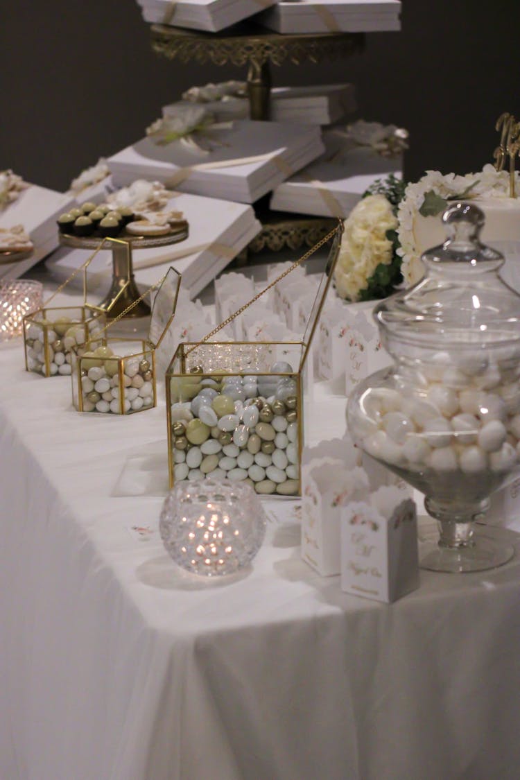 Wedding Decoration, Sweets And Gifts On A Table With White Tablecloth