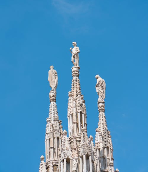 Decorative Tower with Figurines against Blue Sky