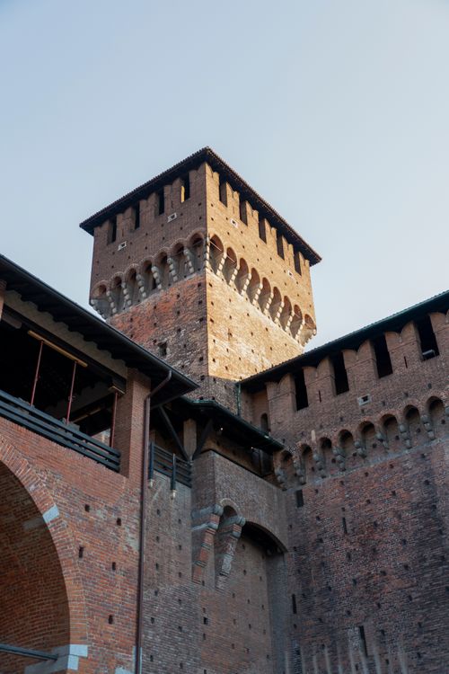 Free Low angle shot of the medieval Sforzesco Castle tower in Milan, showcasing its historic brick structure. Stock Photo