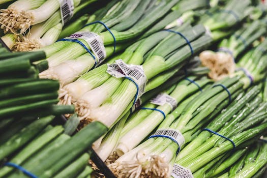 Close-up of fresh green onions on display at a local grocery market.