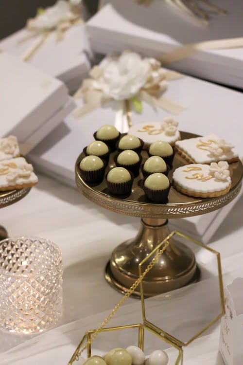 White and Black Cupcakes on Gold Stand