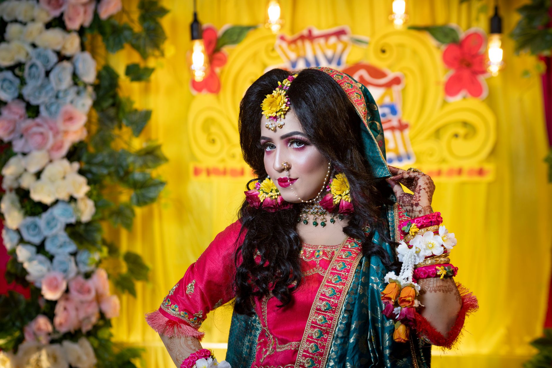 Elegant South Asian bridal portrait featuring colorful traditional attire and jewelry.