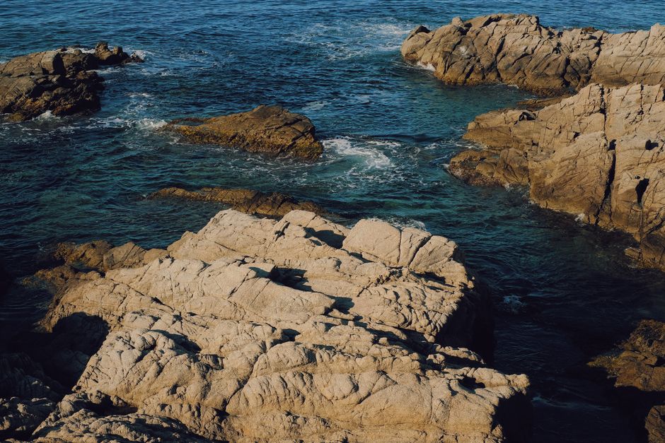 Stunning rocky coastline and blue waters of Costa Brava, Catalonia, Spain, captured in bright daylight.