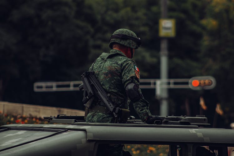 Soldier Standing On A Vehicle